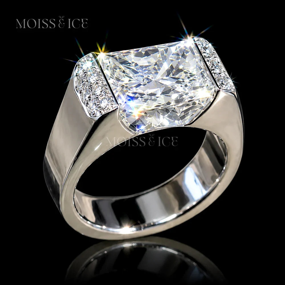 A Moiss & Ice bold statement mens ring featuring a 5 carat rectangular radiant-cut vvs moissanite center stone in a polished white gold setting with smaller accent round moissanite stones on the shoulders - the Raj