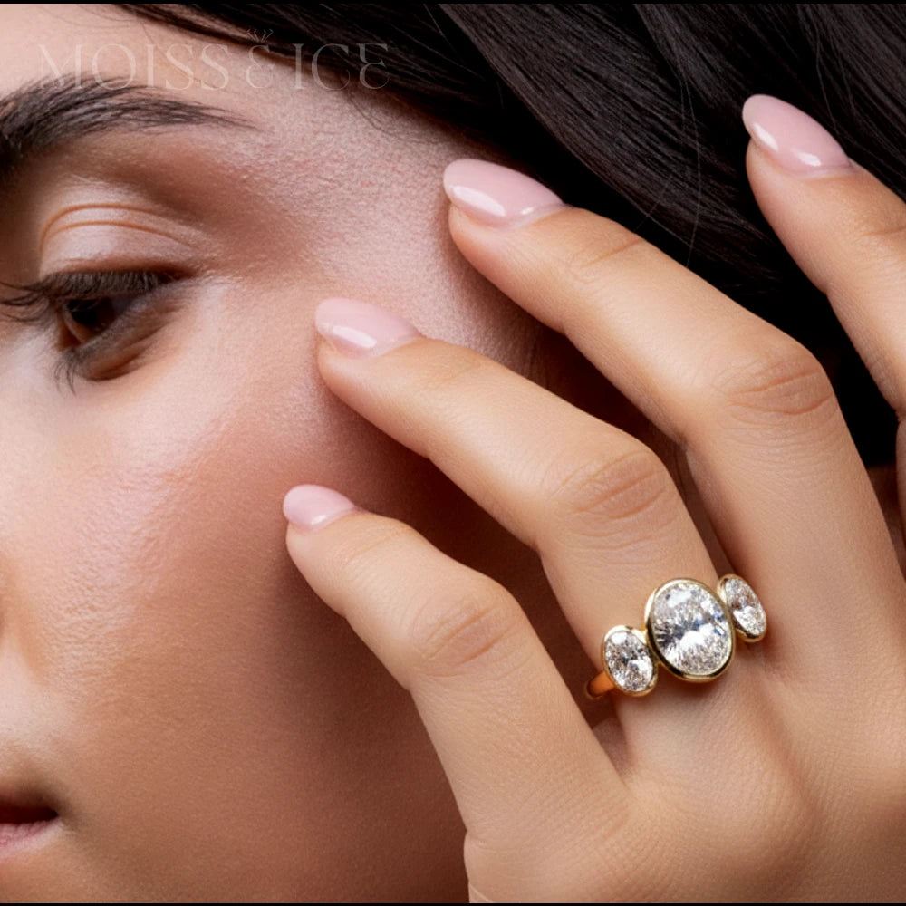 Close up of woman wearing 3 stone moissanite ring - oval cut