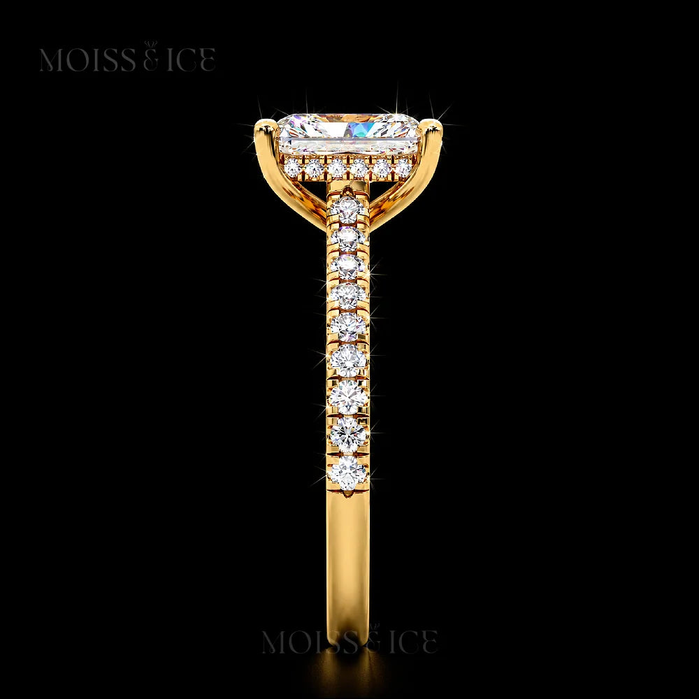 Side view Radiant cut Gold Moissanite Engagement Ring with a hidden halo, diamond bridge and Pave band. The Aavya Moiss and Ice Canada