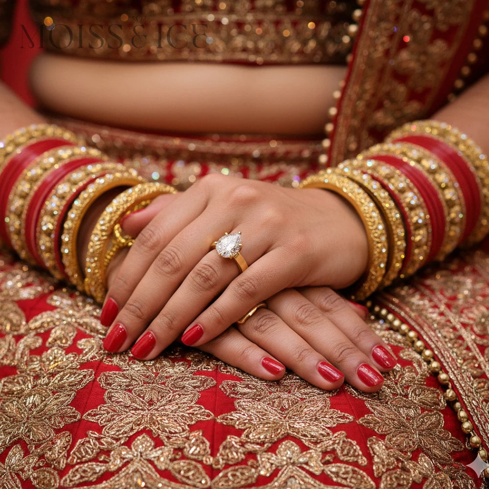 Women wearing pear shaped / tear drop shaped Moiss and Ice Canada - SHAKTI IGI Certified Lab Diamond engagement ring with Indian outfit.