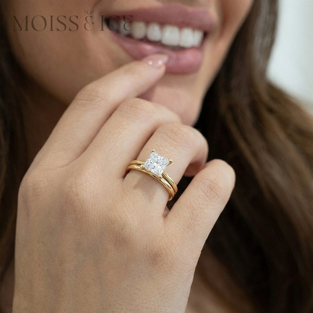 Close-up of a hand wearing a gold IGI Certified Lab Diamond engagement ring, from MOISS & ICE the Rajkumari