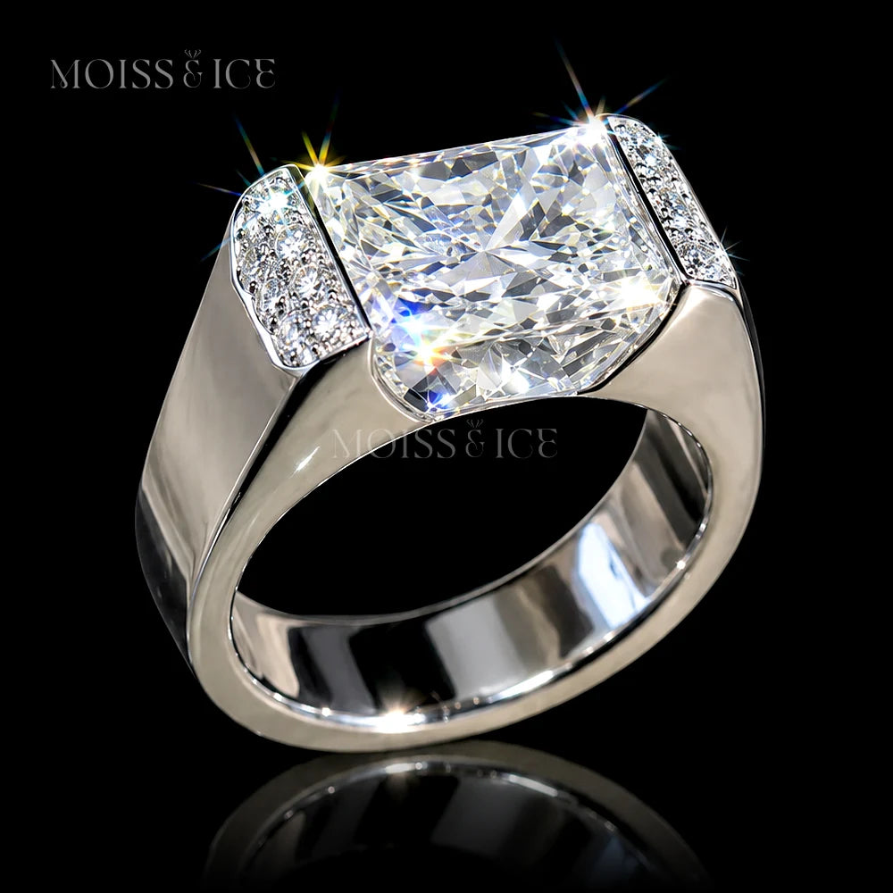 A Moiss & Ice bold statement mens ring featuring a 5 carat rectangular radiant-cut vvs moissanite center stone in a polished white gold setting with smaller accent round moissanite stones on the shoulders - the Raj