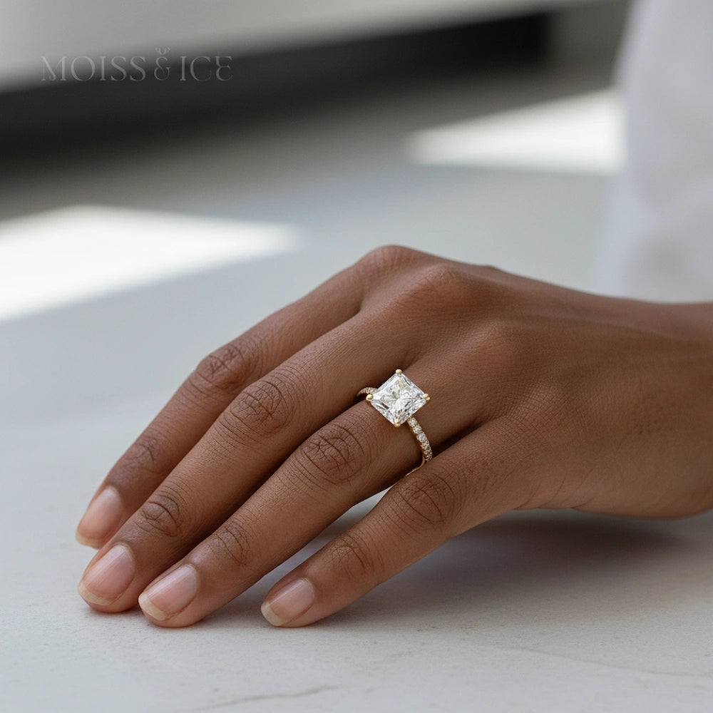 Hand wearing Moiss and Ice Indira Princess cut Gold Moissanite Engagement Ring