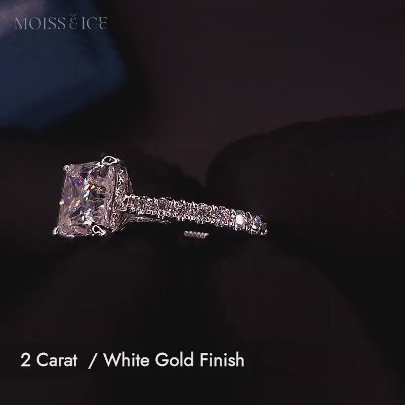 Video of a 2 carat princess cut moissanite engagement ring with pave band and hidden halo, and bridge with stones in white gold