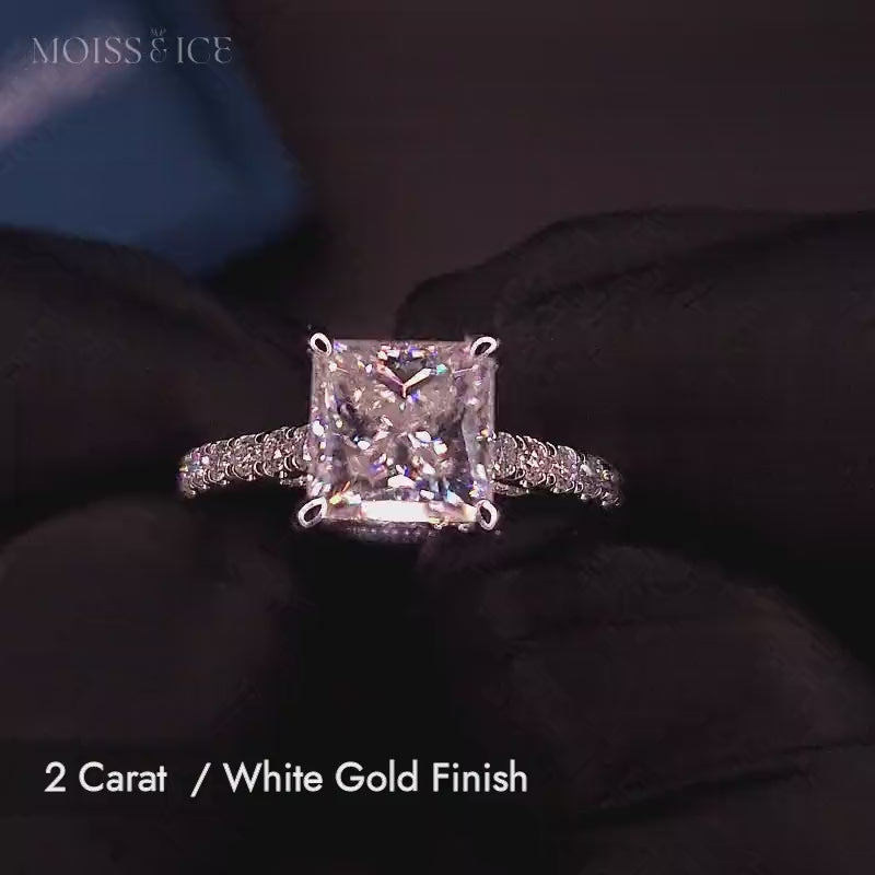 Video of a 2 carat princess cut moissanite engagement ring with pave band and hidden halo, and bridge with stones in white gold