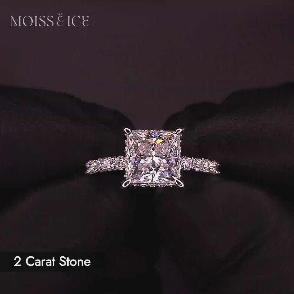 Video of a 2 carat princess cut moissanite engagement ring with pave band and hidden halo in white gold