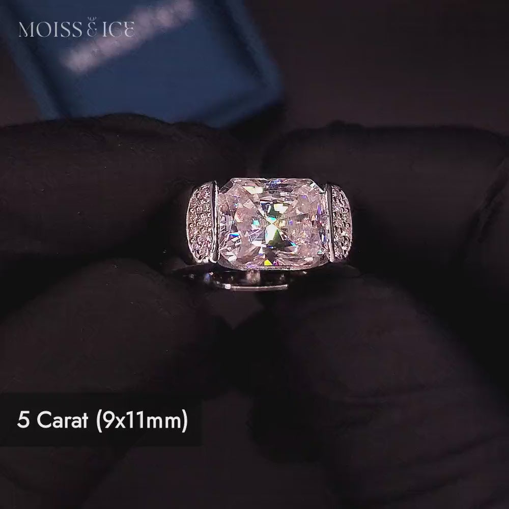 Close up video of a bold statement mens moissanite ring featuring a 5 carat rectangular radiant-cut vvs moissanite center stone in a polished white gold setting with smaller accent round moissanite stones on the shoulders - the Raj