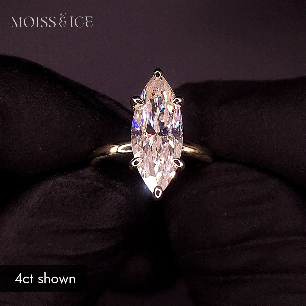 Close up on a 4 carat Marquise moissanite engagement ring in gold