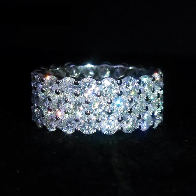 Close up a mens moissanite diamond ring rotating showing sparkling stones