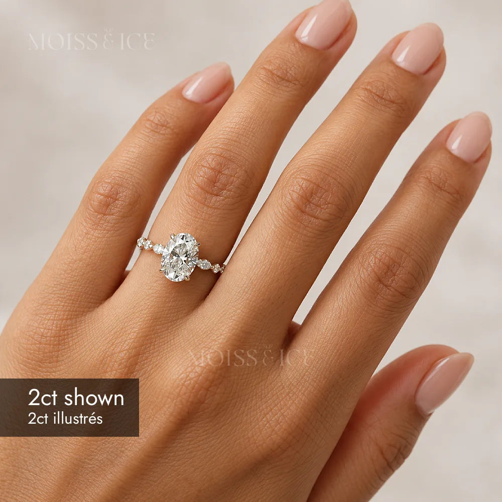 woman wearing 2ct lab-grown diamond engagement ring with oval stone and marquise stone band by Moiss & Ice Canada